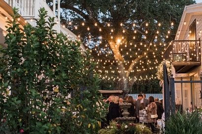 Courtyard at Grand Magnolia full of Event Guests with Market Lighting above the crowd.