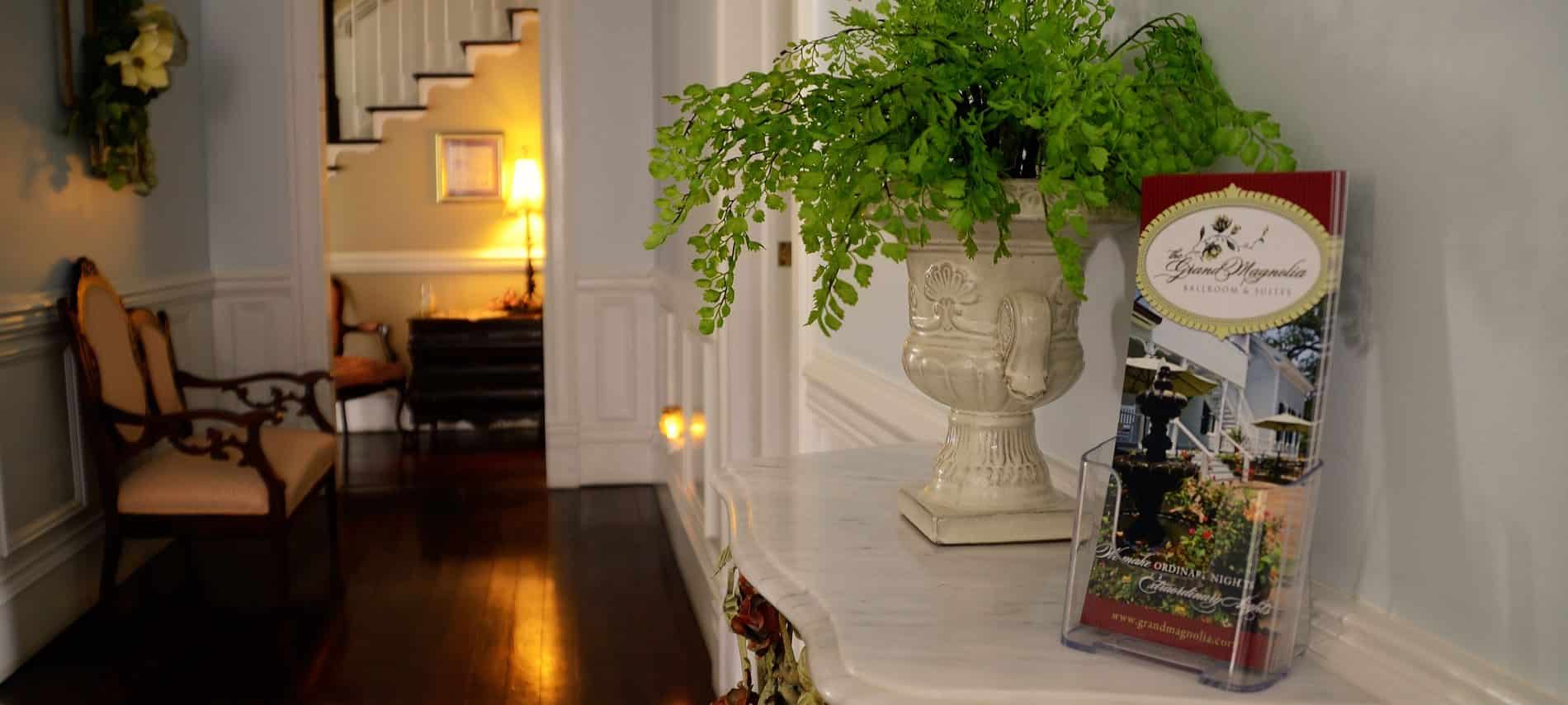 Interior hallway with white wainscoting, wood floors, and elegant decor