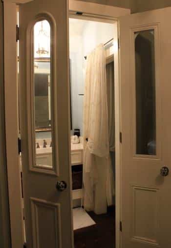 New Orleans guest bath seen through double glass doors