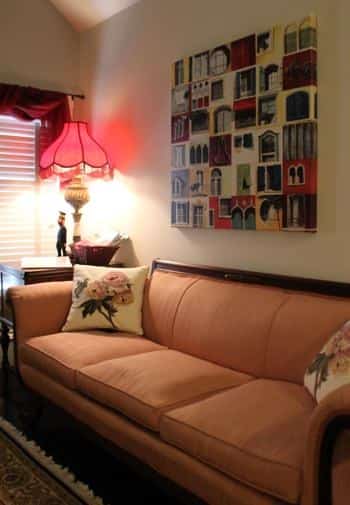 Savannah guest room with vaulted ceiling, sofa with apricot colored cushions, and side table with lamp next to window