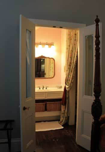 Savannah guest room with view of guest bath from open double French doors